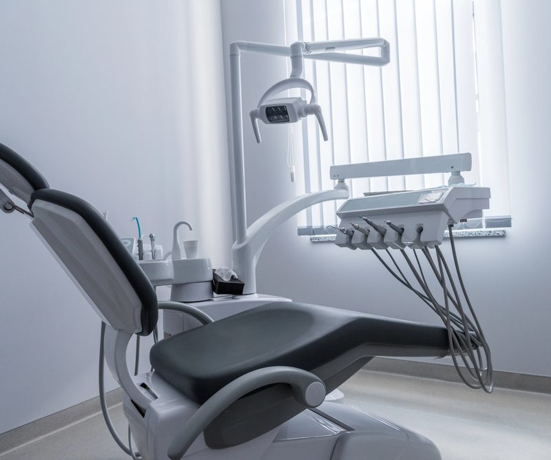 Empty dentist chair with a display of dental tools